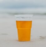 glass of beer on the sand